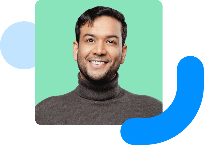 Image shows a smiling man with a green background.