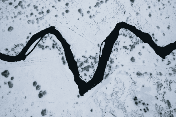 Aerial view of a winding river through a snowy landscape